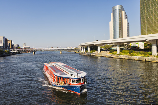Tokyo, Japan - April 09, 2023: cruise ship on the Sumida river in Tokyo. Sumida river is a major river in the city that flows through central Tokyo