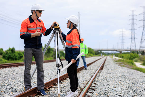 istock Engineer use theodolite equipment and Blueprint surveying construction worker on Railway site. 1763308805