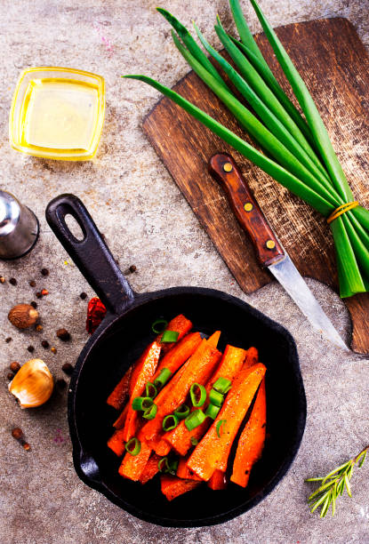 istock Fried carrots with green herbs in baking tray, close up 1763320255