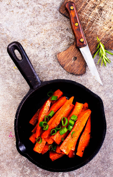 istock Fried carrots with green herbs in baking tray, close up 1763320258