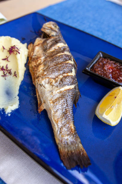 istock Seabass baked with vegetables, lemon and mashed potatoes on plate 1763320281