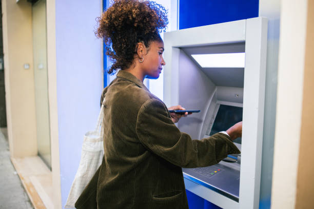 istock Woman using ATM before shopping in the city 1763323993