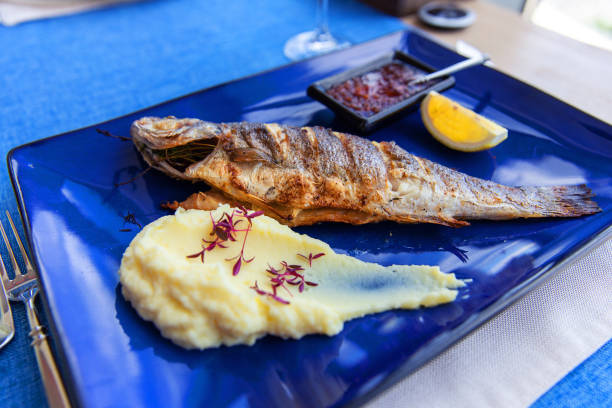 istock Seabass baked with vegetables, lemon and mashed potatoes on plate 1763324337
