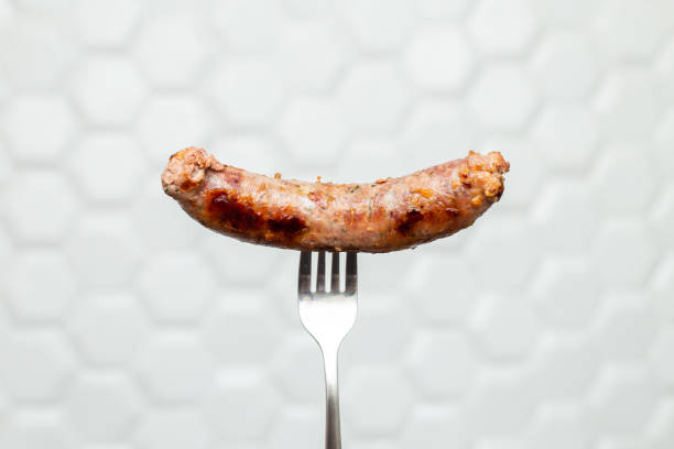 istock Grilled sausage. Hot sausage on a fork. 1763331922