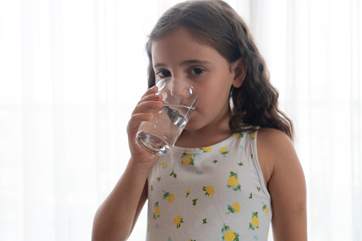 Little girl offer clean mineral water for body refreshment