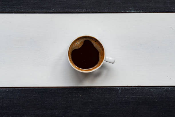 Two hot cup of coffee on brown background with copy space