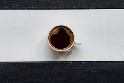 istock Cup of hot coffee on wooden background with copy space 1763335526