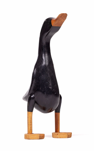 Funny wooden black duck on a white background