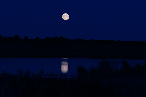 Moon Rising over and reflected in Frampton Marsh, Lincolnshire, England