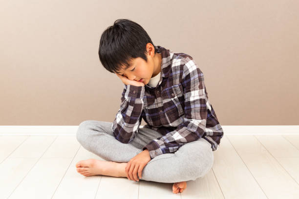 istock A boy feeling depressed in his room. 1763353831