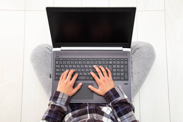 istock The hands of a child using a laptop. 1763355564