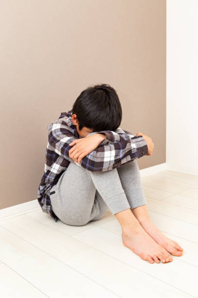 istock A boy feeling depressed in his room. 1763356851
