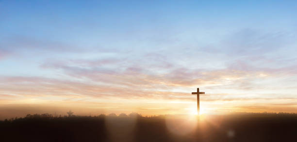 istock Christian wooden cross on sunrise background 1763357926