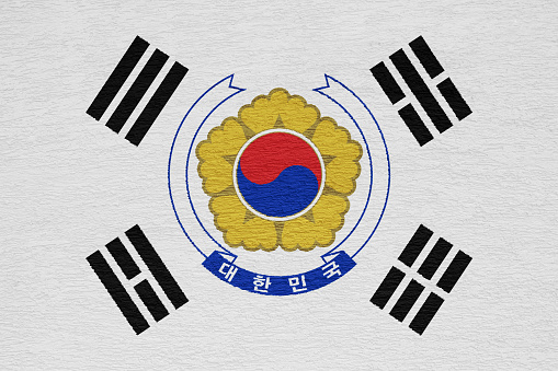 Flag and coat of arms of Republic of Korea on a textured background. Concept collage.