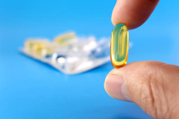 istock A man holds a polyunsaturated fatty acid complex capsule in his hand. Prevention and treatment of ischemic heart disease, atherosclerosis of cerebral vessels. 1763394525