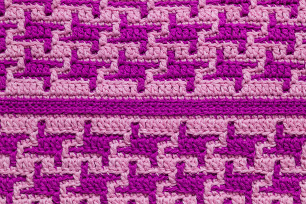 istock Bright pink purple crochet mosaic texture with repeating abstract pattern. Knitted background. 1763403742