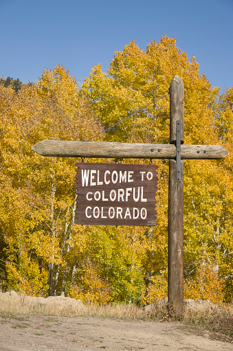 On the New Mexico and Colorado border, a “Welcome to Colorado” sign stands in the yellow aspen on the Cumbres Pass in the San Juan mountains.