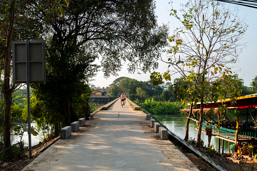 Looking towards Don Khon Island,along the French colonial bridge,a popular landmark and sunset viewpoint,for tourists to cross by foot or bicycle,or relax on as sun sets.
