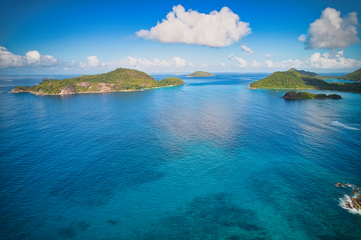 Drone shot from port glaud beach of therese island, conception island, Lilette island and the port launay area, turquoise water and calm sea, Mahe Seychelles