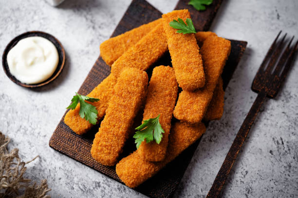 istock Fresh prepared fish sticks with sauce 1763440401