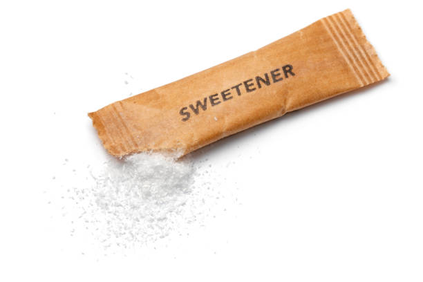Sweetener powder from a disposable sachet isolated on white background close up