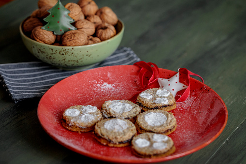 Crescent Christmas Cookies with walnuts covered with sugar powder. Delicious homemade dessert in a shape of half moon.