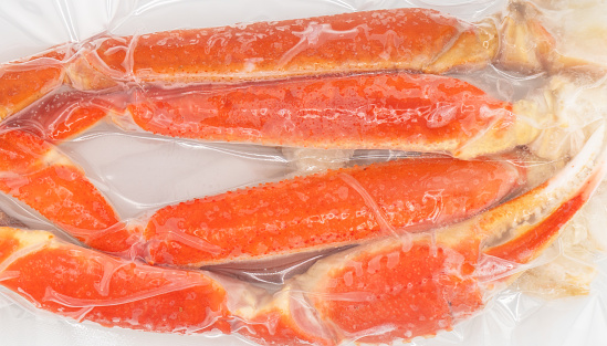 Vacuum packaged Peruvian Southern King crab leg texture background. Crab claws in vacuum package background