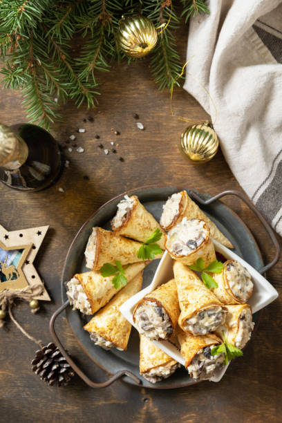 istock Creative appetizers christmas. Lavash roll cone with chicken and mushroom salad on a plate. Top view, flat lay. 1763506295