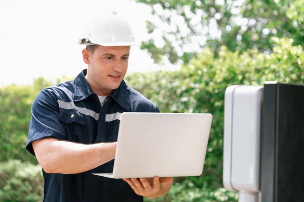 istock Qualified technician working with laptop for home EV station. Synchronos 1763514804