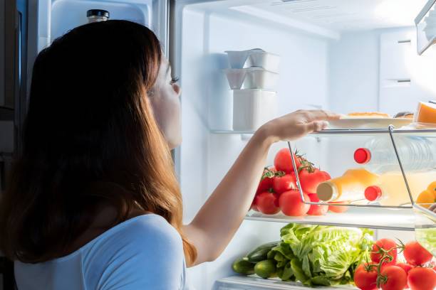 istock Woman Looking At Food In Refrigerator 1763521158