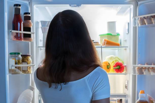 istock Young Woman Looking In Fridge 1763521167