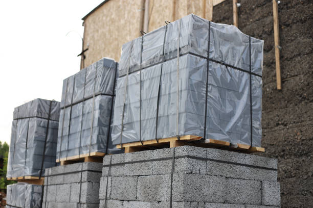 istock Paving stone pack in cellophane on wooden pallets for house building close-up. Stack of concrete blocks. 1763525065