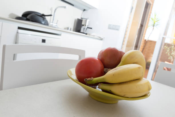 istock white and modern kitchen, on the table a fruit bowl with bananas and tomatoes 1763562591
