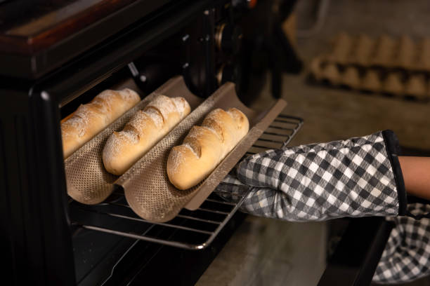 istock Woman hand pull bread out of the oven 1763602925