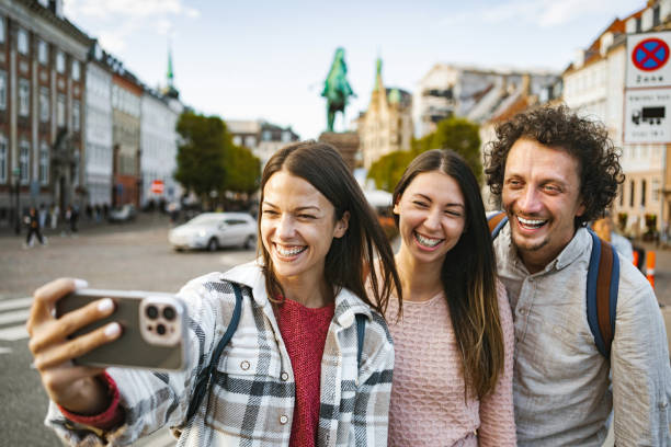 istock Three Caucasian friends taking selfies while exploring the city at sunset 1763621499