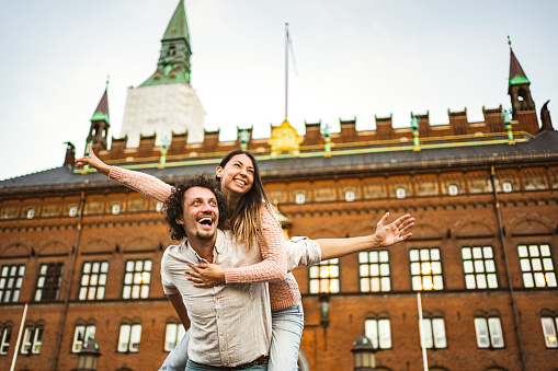 Romantic couple of tourists having fun while exploring the city of Copenhagen