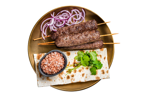 Lamb meat kofta kebab, onion and flat bread on plate.  Isolated on white background