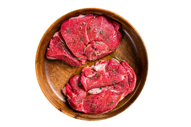 istock Fresh Mutton chop leg steaks, uncooked lamb meat with herbs.  Isolated on white background. 1763625871