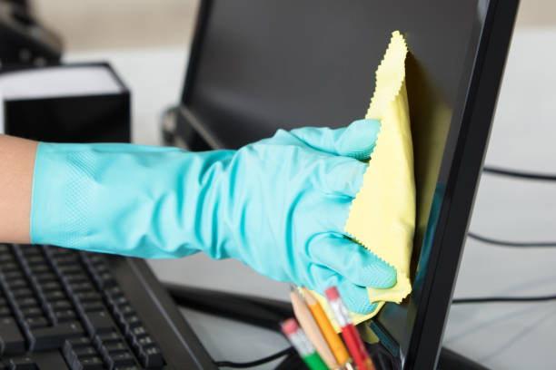 istock Woman Cleaning Desktop Screen With Rag 1763630263