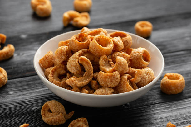 istock Crispy Pork crackling, scratchings. deep fries in white bowl 1763634711