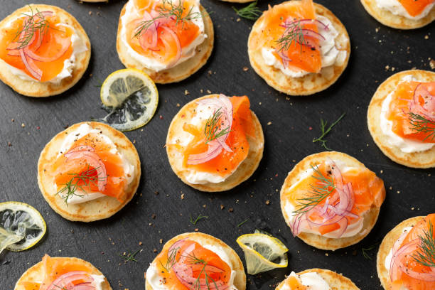 istock Mini blini pancakes with soft cheese, cold smoked salmon and dill 1763636834