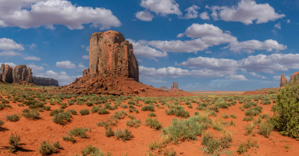 Cly Butte Monument Valley, on the Arizona - Utah border, gives us some of the most iconic and enduring images of the American Southwest.  The harsh empty desert is punctuated by many colorful sandstone rock formations.  It can be a photographer's dream to capture the ever-changing play of light on the buttes and mesas.  Even to the first-time visitor, Monument Valley will probably seem very familiar.  This rugged landscape has achieved fame in the movies, advertising and brochures.  It has been filmed and photographed countless times over the years.  If a movie producer was looking for a landscape that epitomizes the Old West, a better location could not be found.  This picture of Cly Butte was photographed from the Monument Valley Road north of Kayenta, Arizona, USA. merrick butte photos stock pictures, royalty-free photos & images