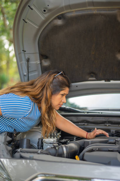 istock Woman trying to see what is wrong with her car 1763663169