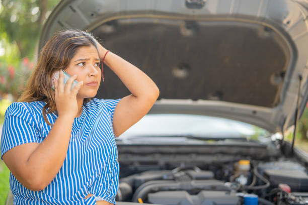 istock Worried woman talking on cell phone asking for help due to mechanical problems with her car 1763670819