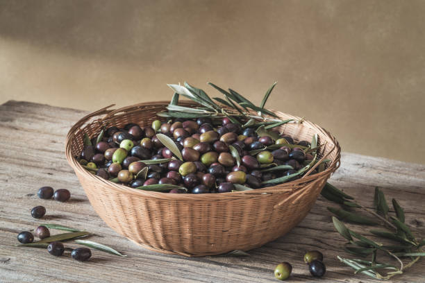 istock Fresh olive berries in basket top view copy space background, harvest concept. 1763671383
