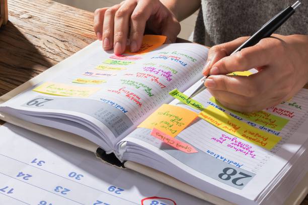 istock Businesswoman Making Schedule On Personal Organizer 1763697309