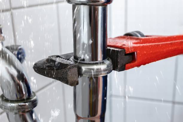 Plumber Repairing Sink Pipe Leakage Male Plumber's Hand Repairing Sink Pipe Leakage With Adjustable Wrench plumb line stock pictures, royalty-free photos & images