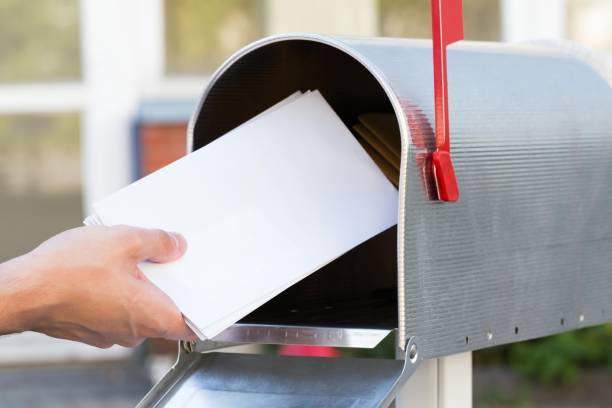 istock Person Putting Letters In Mailbox 1763702945
