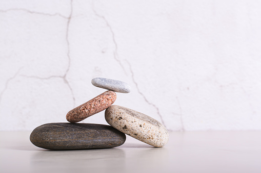 Balancing structure made of smooth sea stones on a table