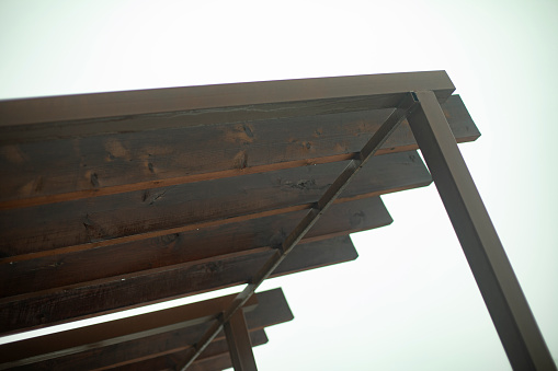 The roof is made of wood. Frame made of steel beams and split planks. Roof Structure Details. Small architecture.